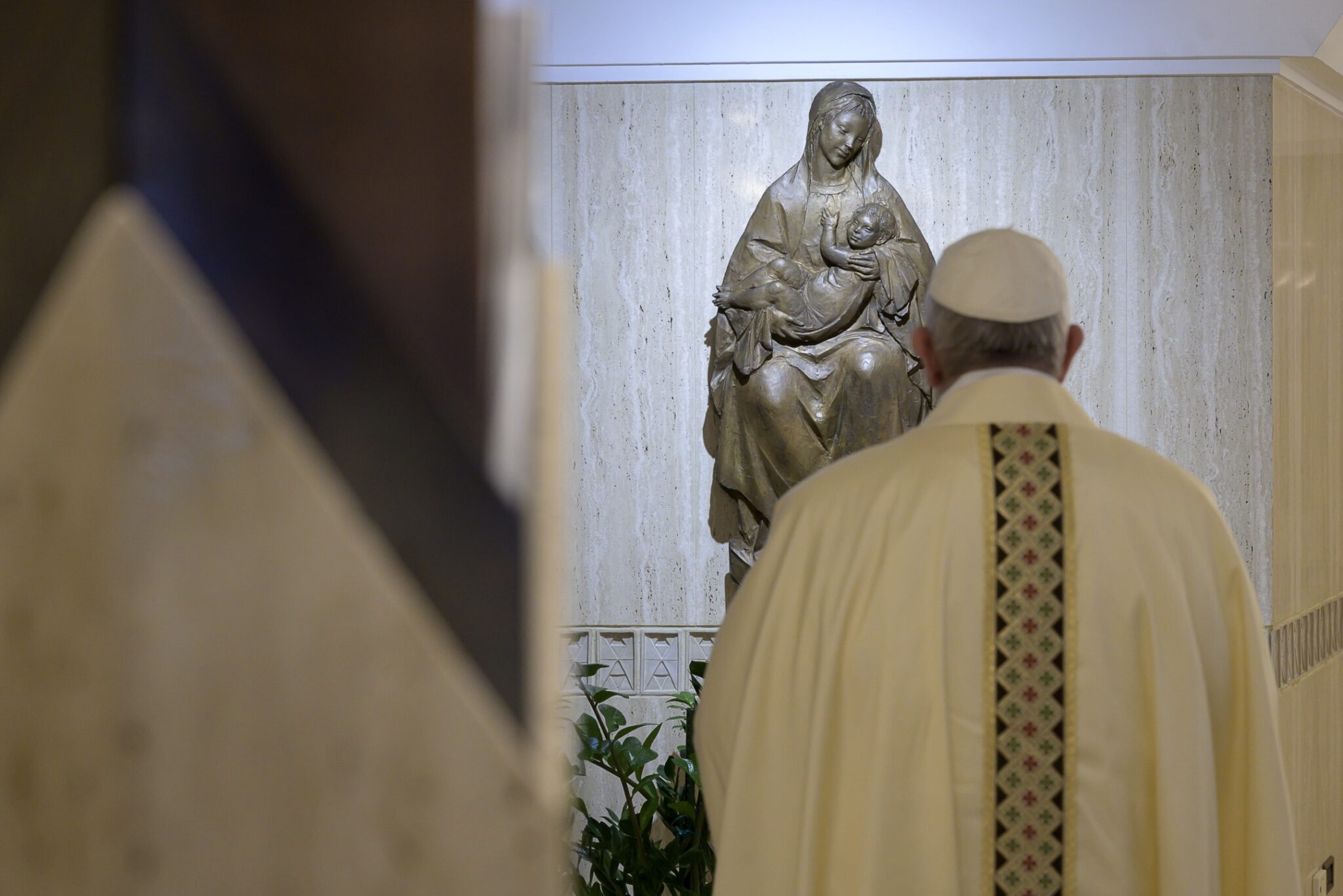 The Pope looking at a statue