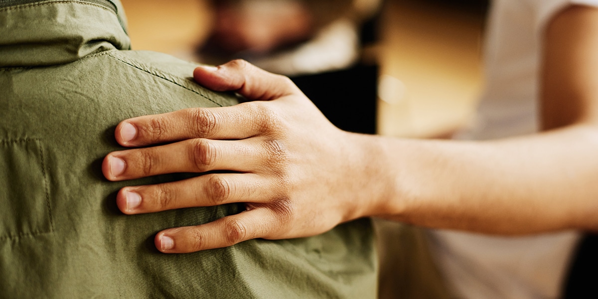 hand on a shoulder as a sign of empathy
