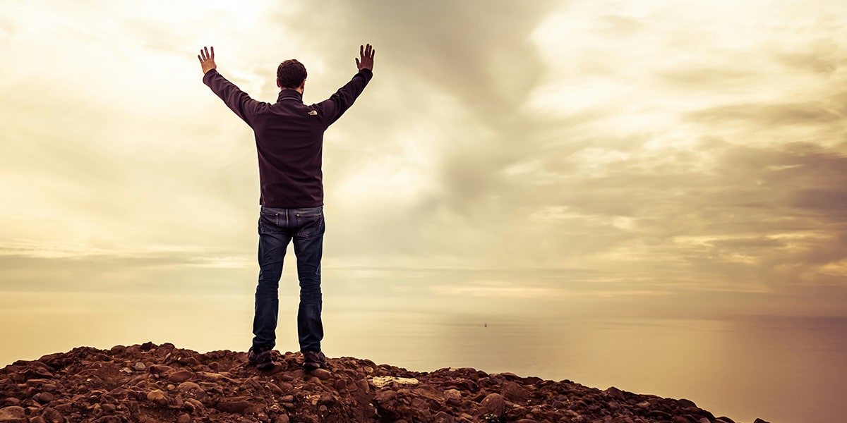 man with raised arms in a sign of surrendering