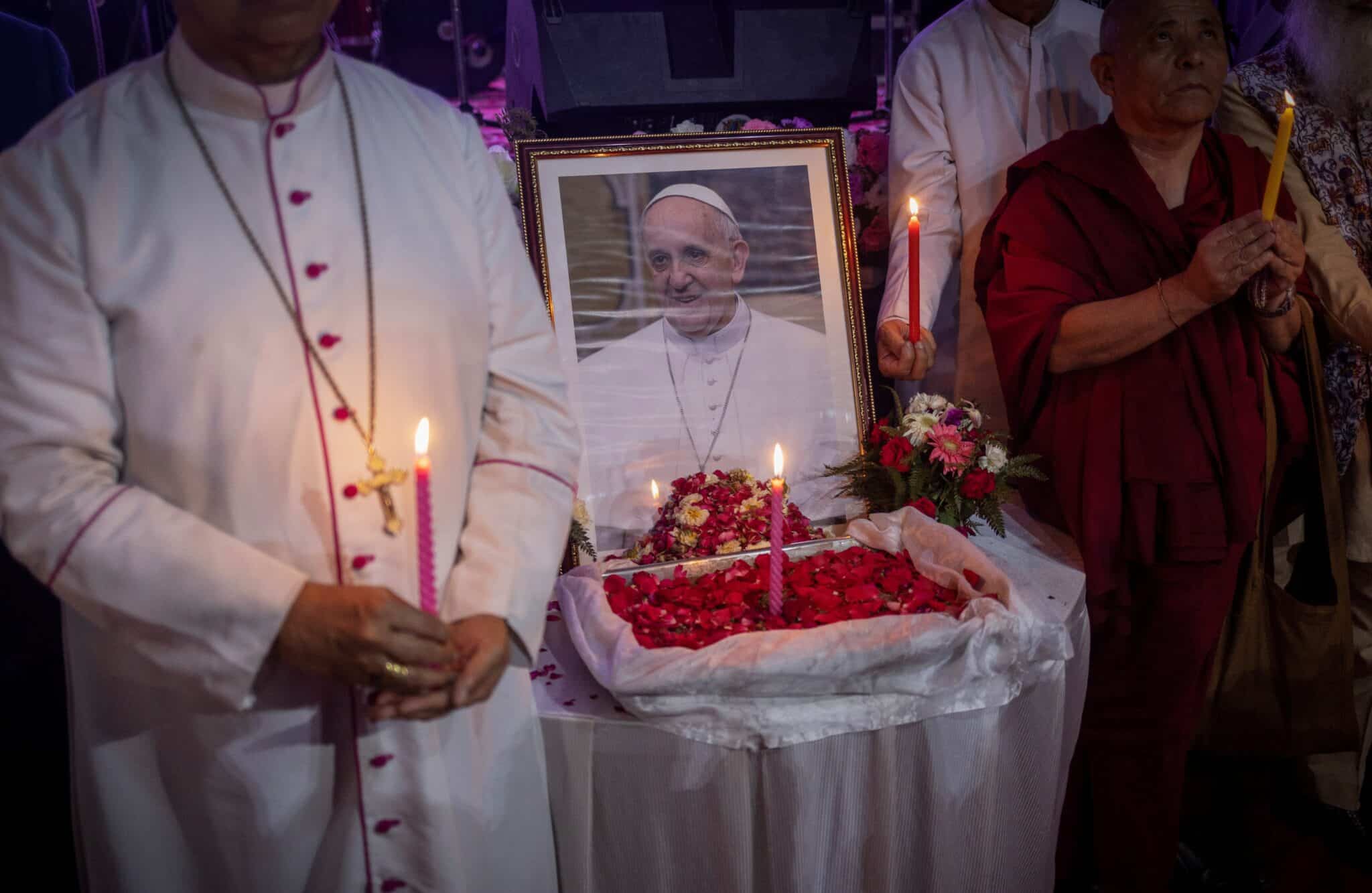 People hold candles in front of a picture of Pope Francis in New Delhi, India, April 21, 2025, after his death was announced by the Vatican. Pope Francis, formerly Argentine Cardinal Jorge Mario Bergoglio, died April 21 at age 88. (OSV News photo/Adnan Abidi, Reuters)