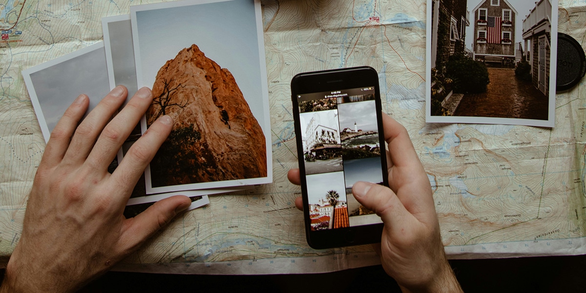 hands holding phone, surrounded by photos