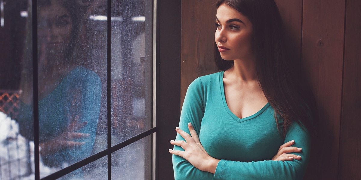woman crossing her arms in front of her chest with a attitude of arrogance and pride.