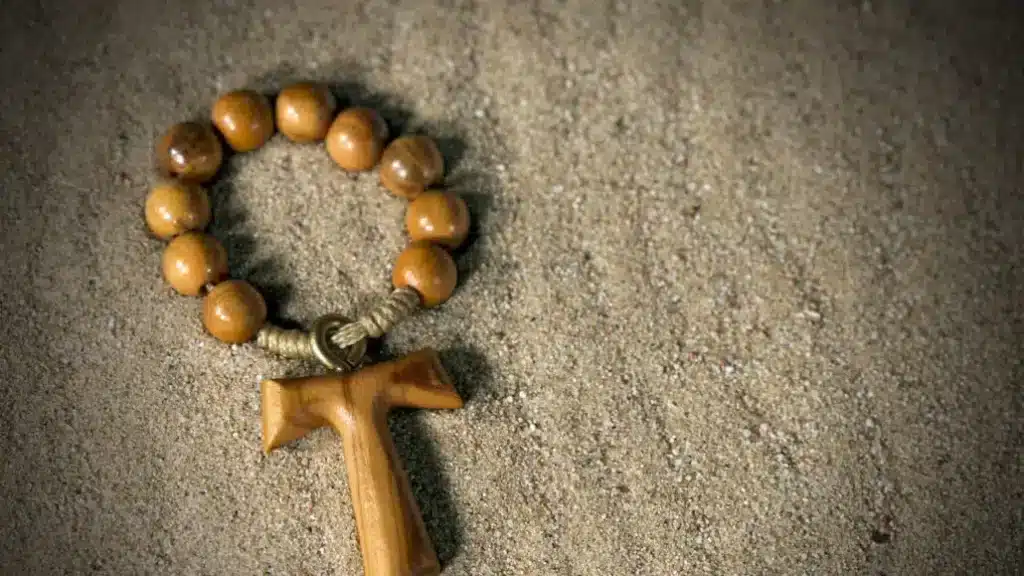 Wooden Tau cross in the sand